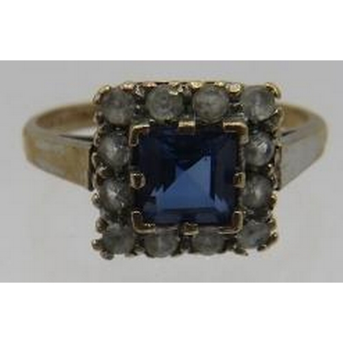 486 - A 9ct yellow gold square set ring with centre sapphire, approx 5mm x 5mm surrounded with 12 white st... 