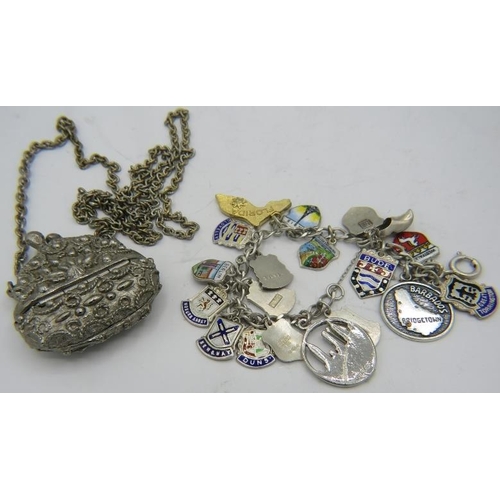 487 - A collection of 19 mainly sterling silver enamelled shield charms on a white metal link bracelet and... 