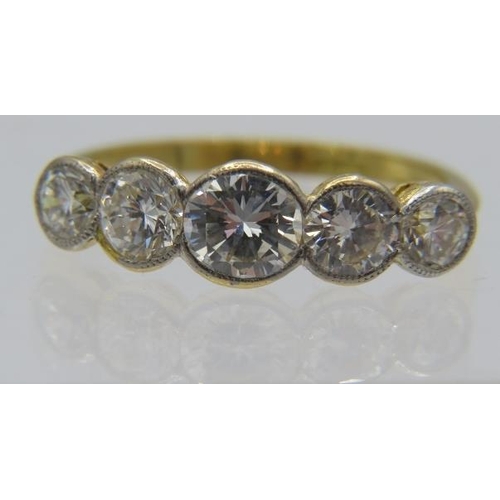 496 - An 18ct yellow gold five stone graduated collet set brilliant cut diamond ring, size N/O. Centre dia... 