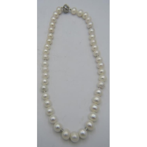 500A - An exceptionally rare strand of soft white Australian Southsea pearls with rose undertones and 8 dia... 