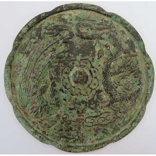 57 - A Chinese bronze Tang dynasty style mirror. Decorated with a dragon and phoenix. Stand included. 19.... 