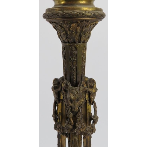 61 - A large gilt bronze triform table lamp, late 19th/early 20th century. Decorated with rams heads mask... 