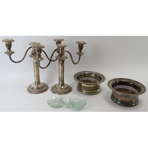 78 - A pair of plated silver wine coasters and a pair of plated silver candelabra. (4 items) Candelabra: ... 