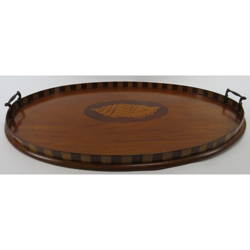 87 - An Edwardian Sheraton Revival twin handled oval tray. The centre marquetry inlaid with a shell pater... 