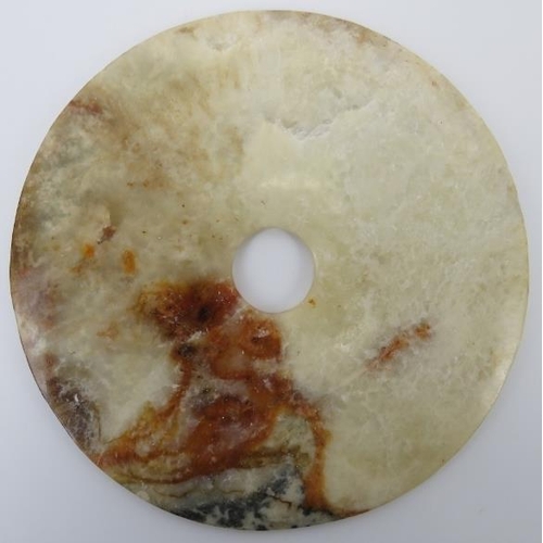 9 - A Chinese white and russet jade bi disc, Neolithic style, probably late 19th/20th century. Supported... 