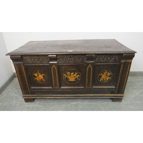 703 - A late 17th/early 18th century panelled oak coffer, the front with carved frieze and marquetry inlay... 