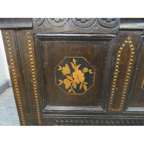 703 - A late 17th/early 18th century panelled oak coffer, the front with carved frieze and marquetry inlay... 