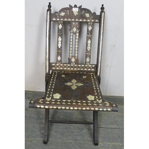 707 - A vintage Syrian hardwood folding chair with turned finials, having profuse mother of pearl inlay, o... 