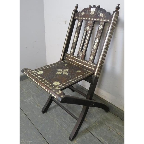 707 - A vintage Syrian hardwood folding chair with turned finials, having profuse mother of pearl inlay, o... 