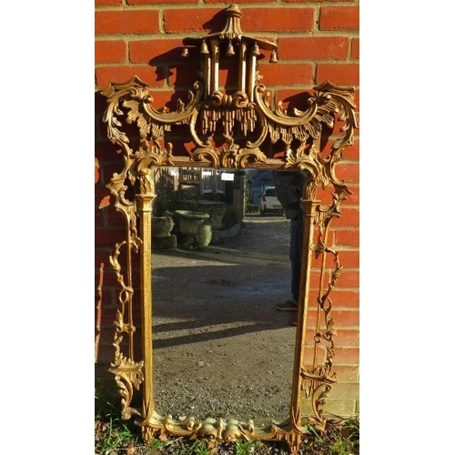 709 - A large vintage wall mirror in the Chippendale taste, within a highly decorative acanthus carved and... 