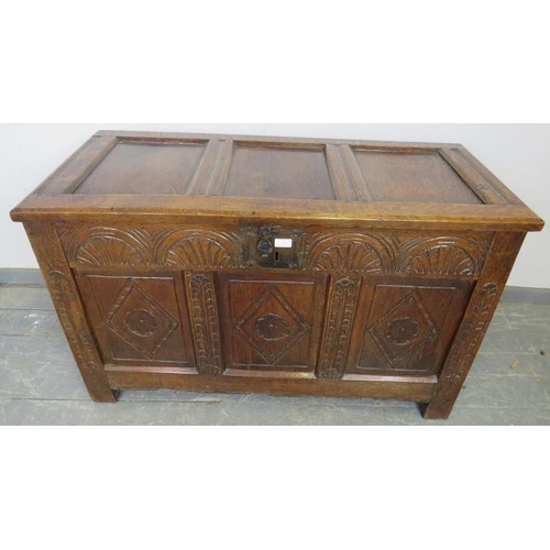 713 - An early 18th century panelled oak coffer, having internal candle box, arcaded frieze and diamond ca... 