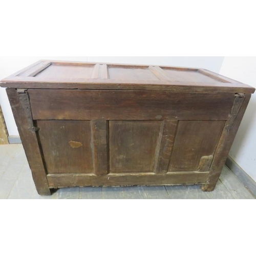 713 - An early 18th century panelled oak coffer, having internal candle box, arcaded frieze and diamond ca... 