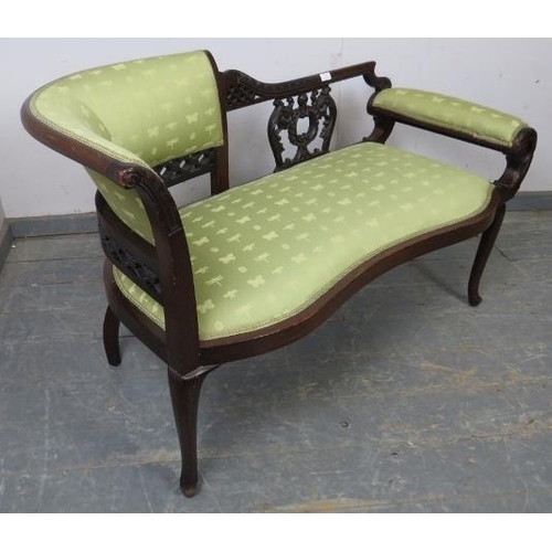 717 - An Edwardian mahogany chaise longue of small proportions, the ornately carved and pierced backrest w... 