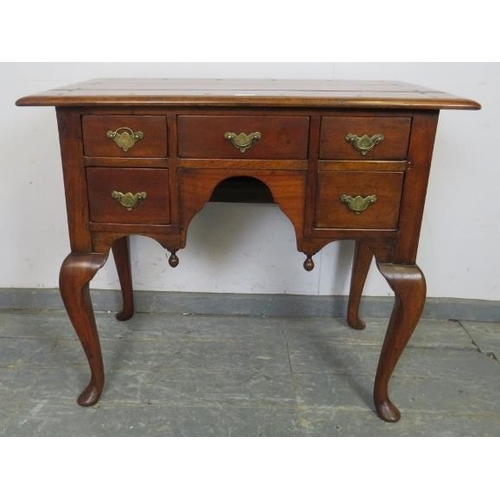 718 - A good quality reproduction cherrywood low boy in the 18th century taste, having a configuration of ... 