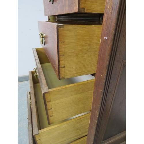 719 - A 19th century oak Wellington chest, having seven long drawers with fancy brass handles, flanked by ... 