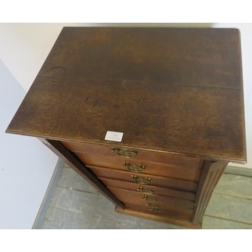 719 - A 19th century oak Wellington chest, having seven long drawers with fancy brass handles, flanked by ... 