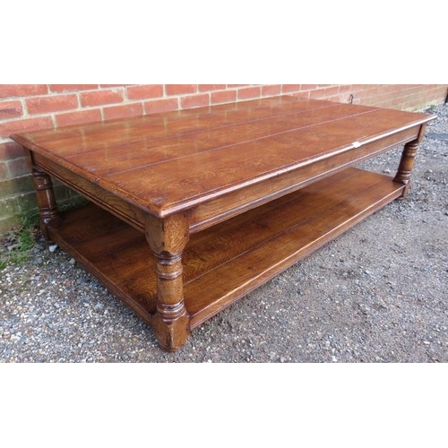 727 - A large antique style solid oak coffee table, on turned and block supports united by an undertier sh... 