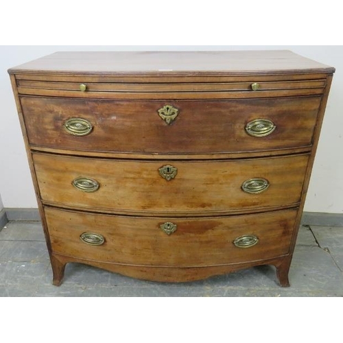 731 - A George III mahogany bow-fronted chest with reeded edge, having a pull-out brushing slide over thre... 