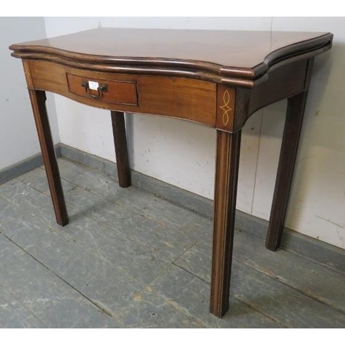 733 - A George III mahogany serpentine fronted turnover tea table, the single drawer with parquetry inlay,... 