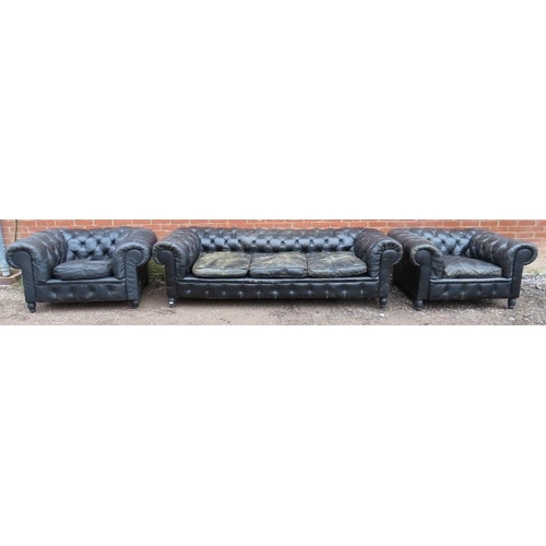 734 - A vintage three-piece Chesterfield suite, comprising a three-seater sofa and two club armchairs, uph... 