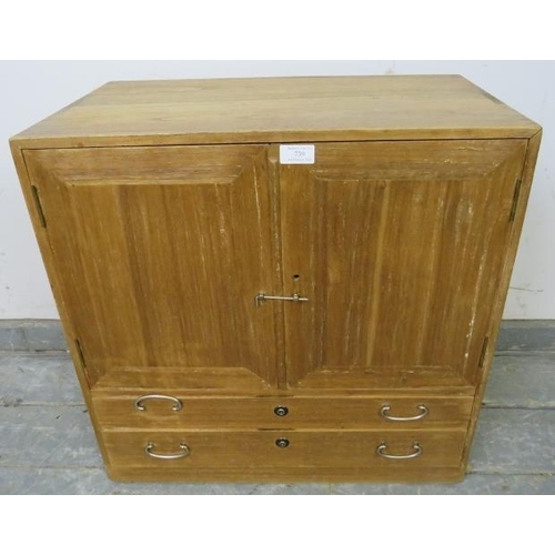 739 - A vintage Japanese cypress wood table-top cabinet, the double doors opening onto two fitted shelves,... 