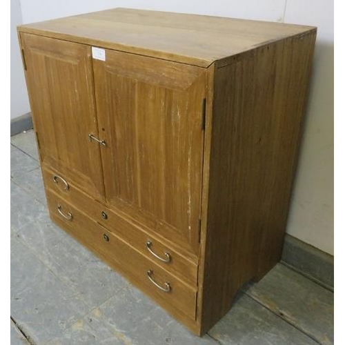 739 - A vintage Japanese cypress wood table-top cabinet, the double doors opening onto two fitted shelves,... 