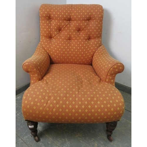 742 - A low and deep Victorian armchair in the manner of Howard & Sons, with scrolled back, reupholstered ... 