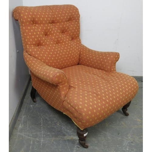 742 - A low and deep Victorian armchair in the manner of Howard & Sons, with scrolled back, reupholstered ... 