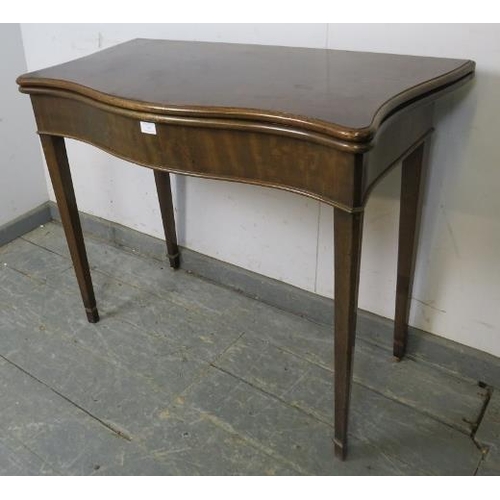 745 - A Georgian mahogany serpentine fronted folding card table, on chamfered tapering square supports. 
H... 