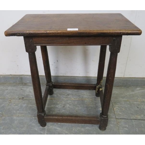 747 - An 18th century joint stool, the loose mahogany top on plain turned oak supports united by stretcher... 