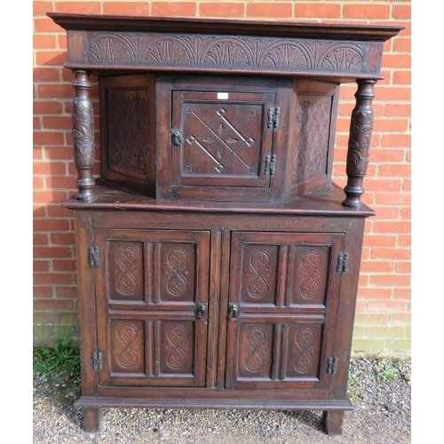 754 - A 17th century and later oak court cupboard, the top section with central cupboard flanked by relief... 