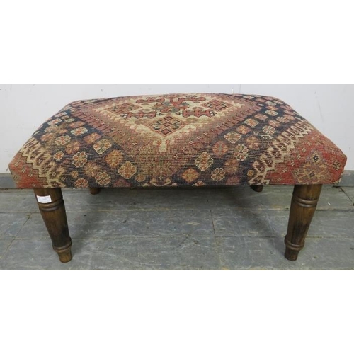 757 - A contemporary footstool recovered with an antique Egyptian carpet, on turned tapering fruitwood sup... 