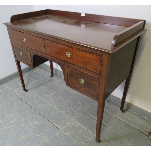 763 - An Edwardian mahogany kneehole writing desk, having ¾ gallery above two long and two short crossband... 