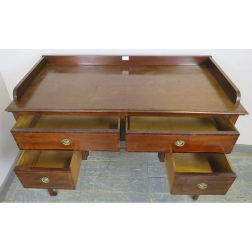 763 - An Edwardian mahogany kneehole writing desk, having ¾ gallery above two long and two short crossband... 