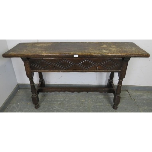 764 - A 19th century oak hall table in the 17th century taste, having one long drawer with diamond carved ... 