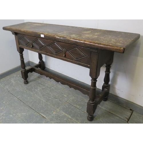 764 - A 19th century oak hall table in the 17th century taste, having one long drawer with diamond carved ... 