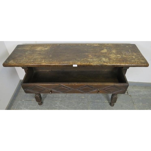 764 - A 19th century oak hall table in the 17th century taste, having one long drawer with diamond carved ... 