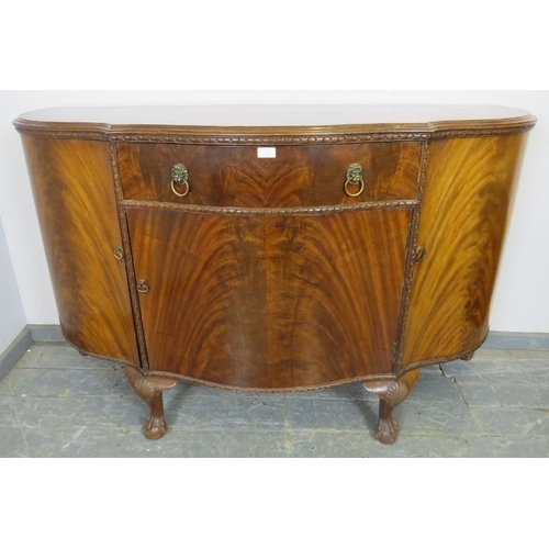 767 - A good quality antique flame mahogany serpentine fronted sideboard in the Georgian taste, housing on... 