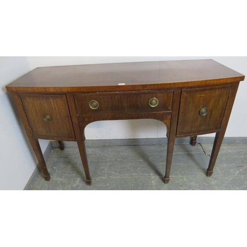 772 - A Regency mahogany bow fronted sideboard, the central drawer flanked by two cupboards, with brass dr... 