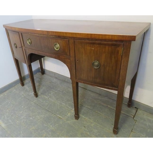 772 - A Regency mahogany bow fronted sideboard, the central drawer flanked by two cupboards, with brass dr... 