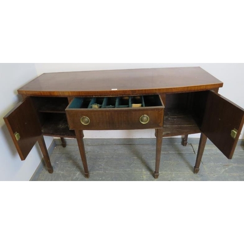 772 - A Regency mahogany bow fronted sideboard, the central drawer flanked by two cupboards, with brass dr... 