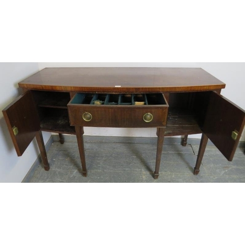 772 - A Regency mahogany bow fronted sideboard, the central drawer flanked by two cupboards, with brass dr... 