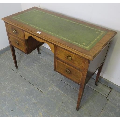 774 - An Edwardian mahogany writing desk, the top with inset gilt tooled leather writing surface, housing ... 