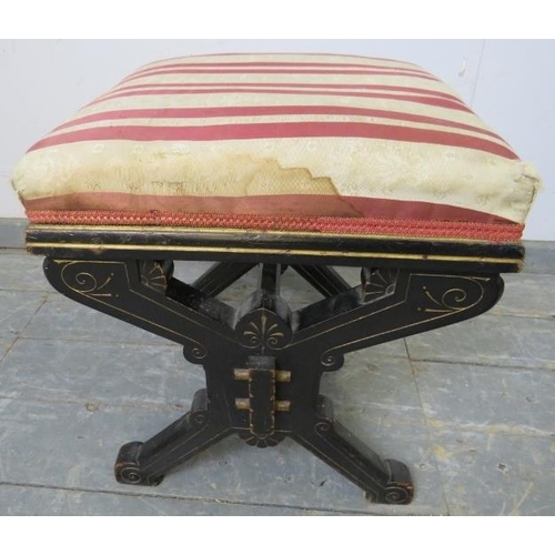 784 - An Aesthetic Movement ebonised ‘X-frame’ stool having carved decoration with gold accents, upholster... 