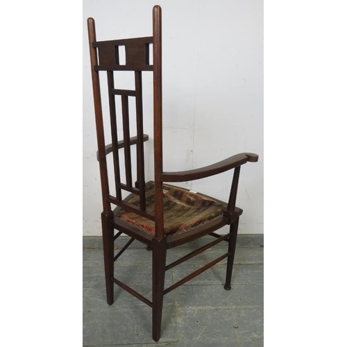 785 - An Arts & Crafts Period mahogany elbow chair.