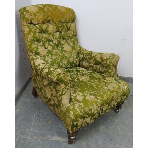 789 - A Victorian low club armchair, upholstered in buttoned green material, on tapered turned mahogany su... 