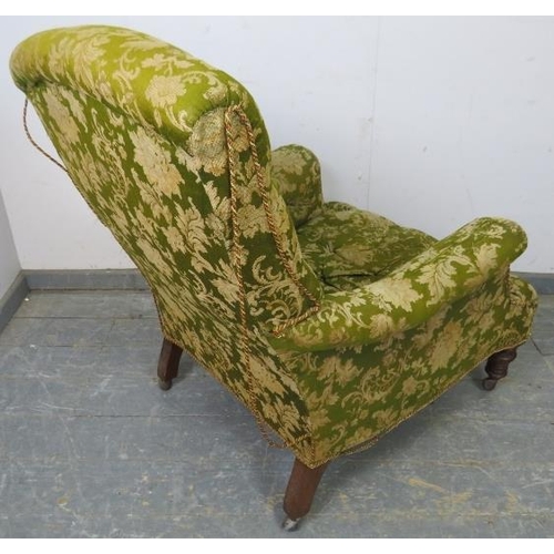 789 - A Victorian low club armchair, upholstered in buttoned green material, on tapered turned mahogany su... 