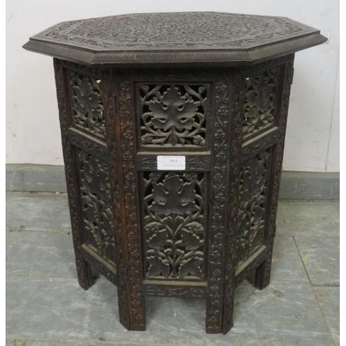 793 - An antique Anglo Indian hardwood octagonal table, the top with relief carved foliate motifs, on a ca... 