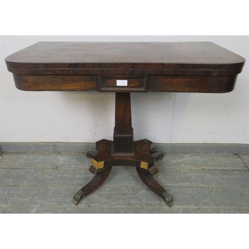 799 - A Regency Period rosewood turnover card table, on a tapered square column with quatreform base termi... 