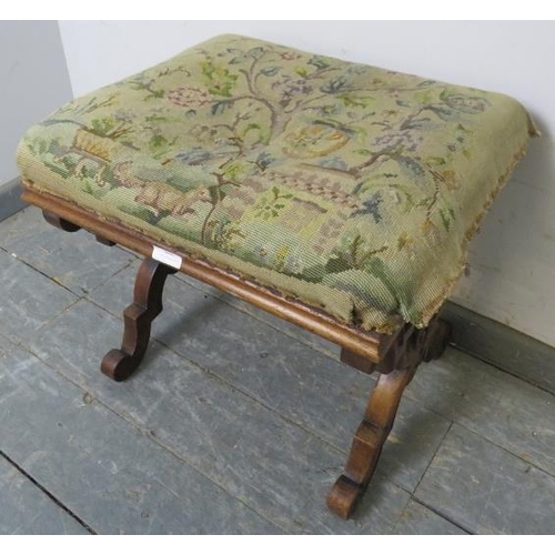 802 - A Victorian mahogany X-Frame tapestry footstool, on double scrolled supports with a turned middle st... 